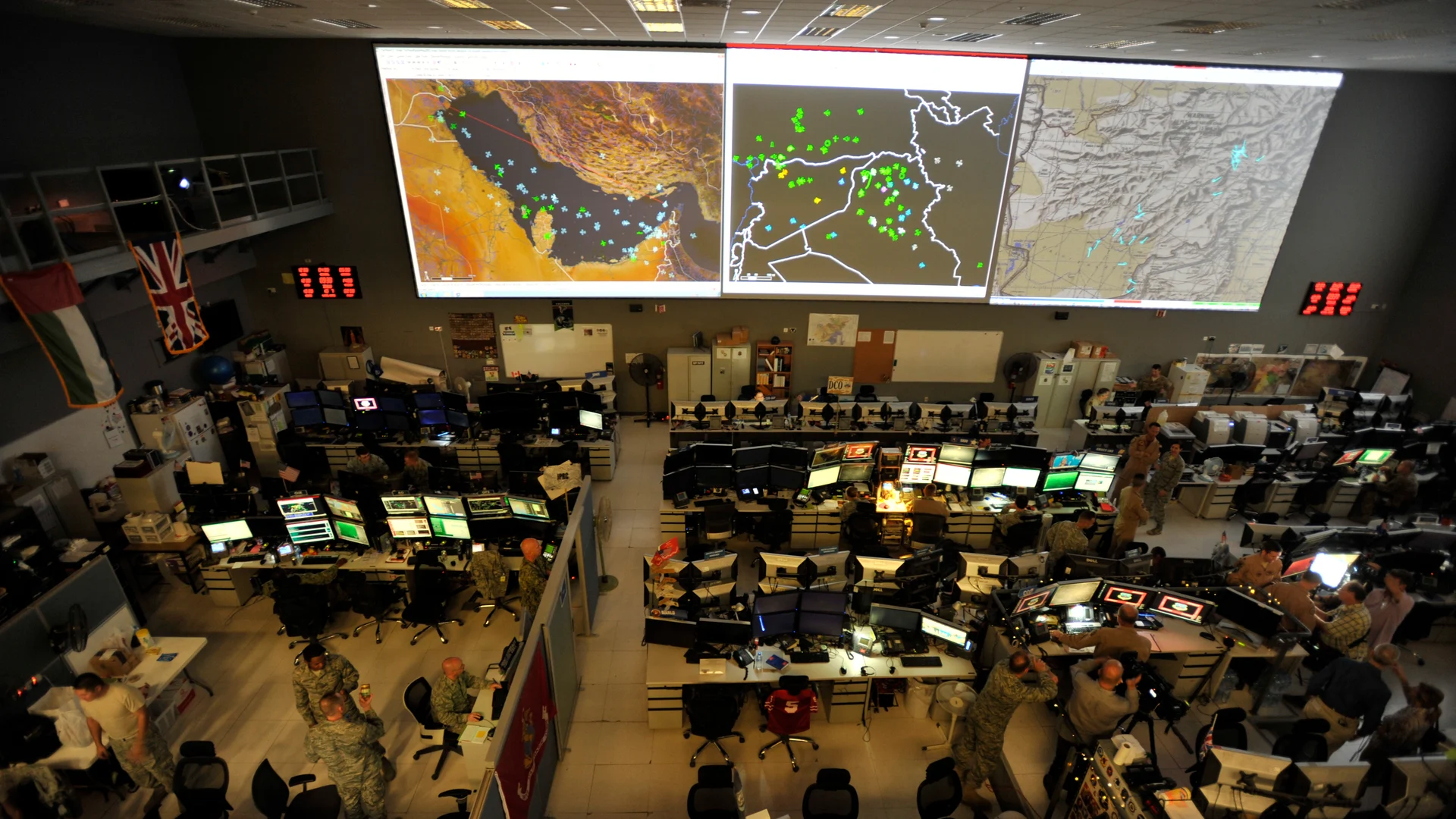 Combined Air Operations Center with personnel and maps at Al Udeid Air Base
