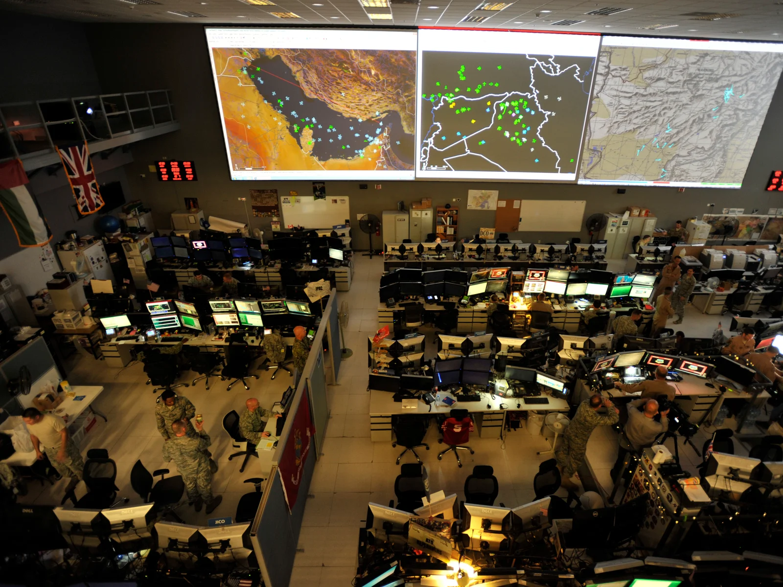 Combined Air Operations Center with personnel and maps at Al Udeid Air Base