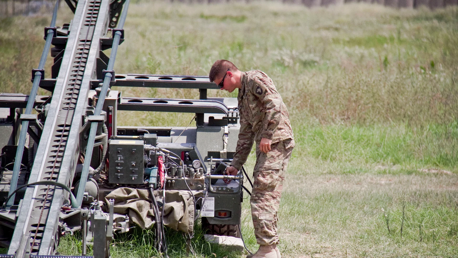 A U.S. Army technician prepares an RQ-7 Shadow drone launcher in Afghanistan
