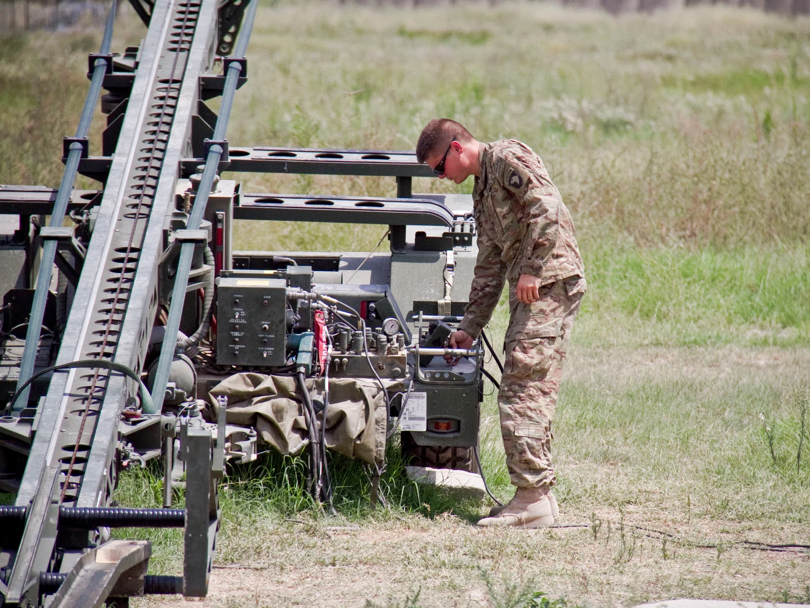 A U.S. Army technician prepares an RQ-7 Shadow drone launcher in Afghanistan