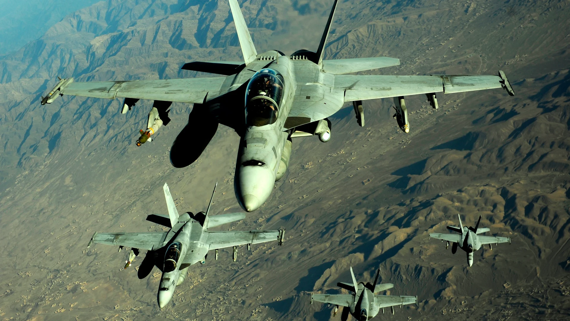 Military aircraft above a mountainous region of Afghanistan
