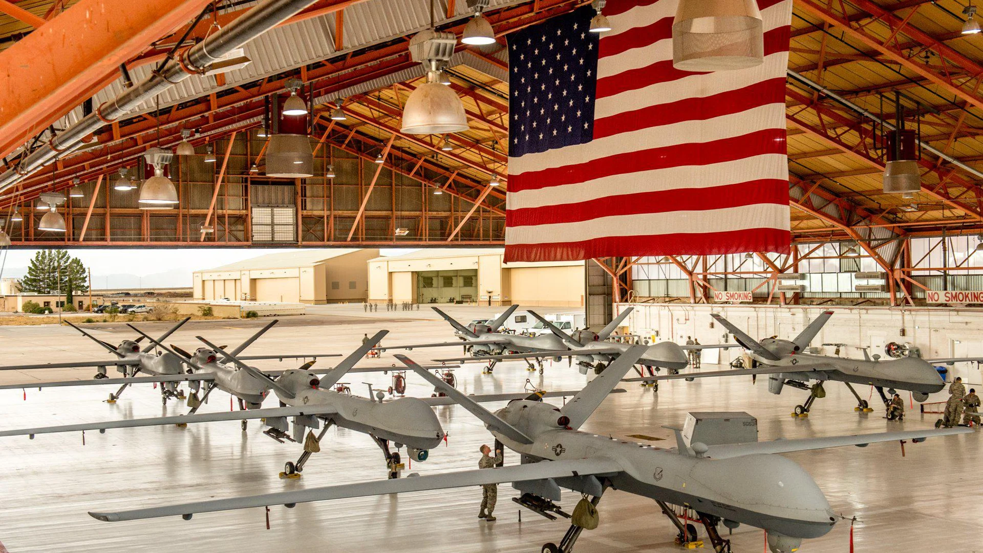 Airmen inspect MQ-9 aircraft in a maintenance hangar at Holloman Air Force Base