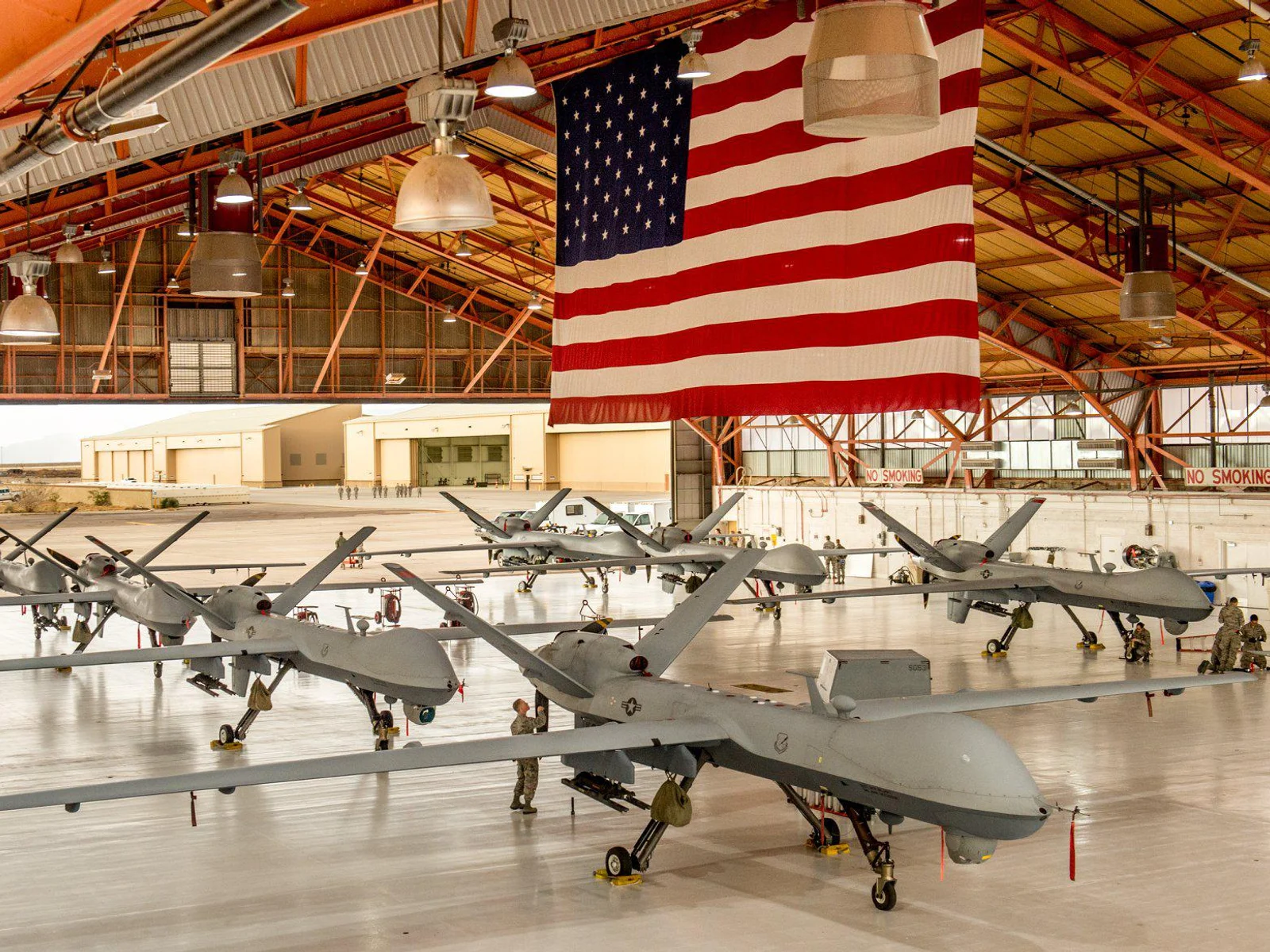Airmen inspect MQ-9 aircraft in a maintenance hangar at Holloman Air Force Base