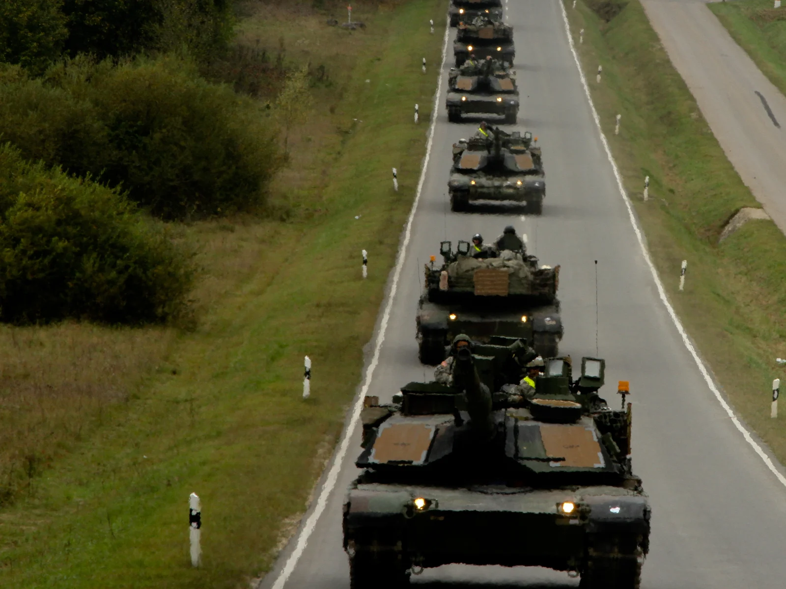 M1A2 Abrams tanks moving in convoy through the German countryside during an exercise